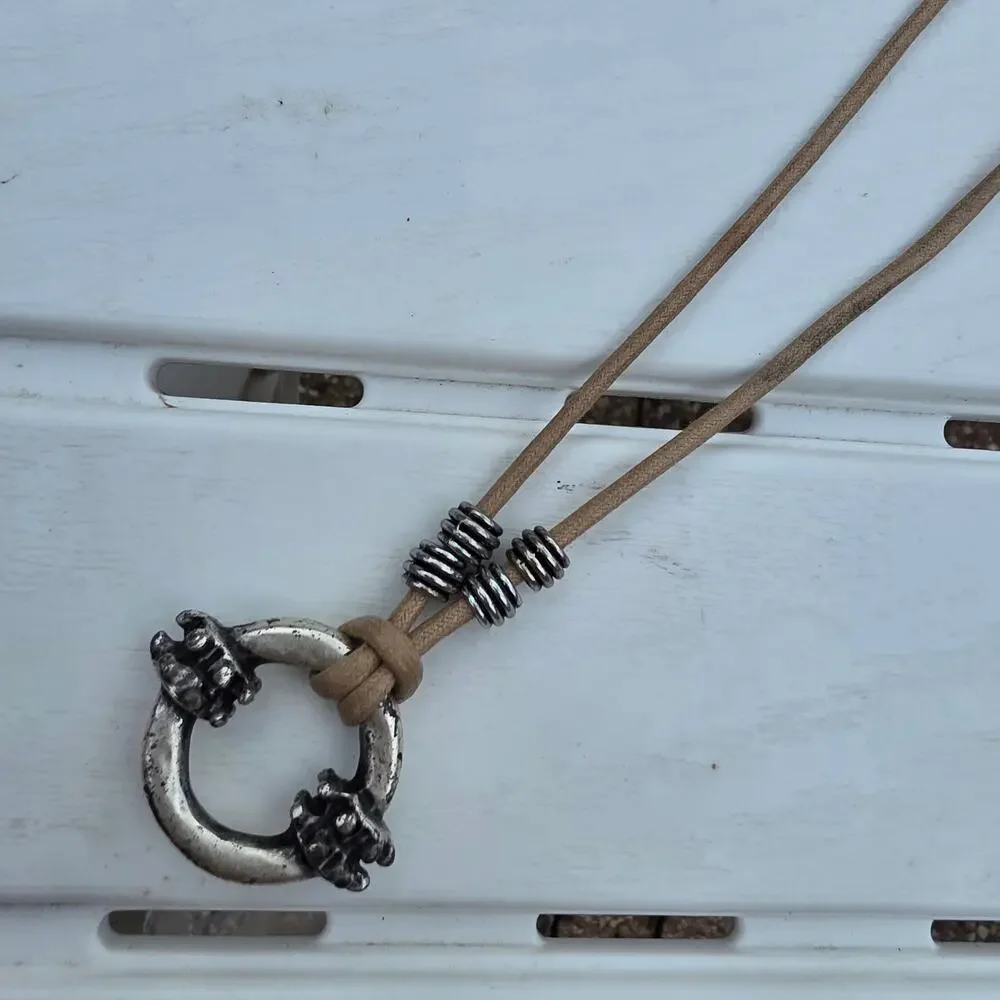 beige leather cord necklace with a silver-tone ring pendant